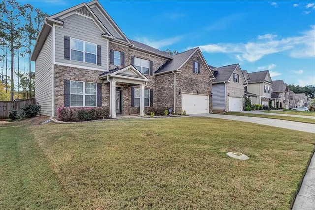 a front view of a house with a garden