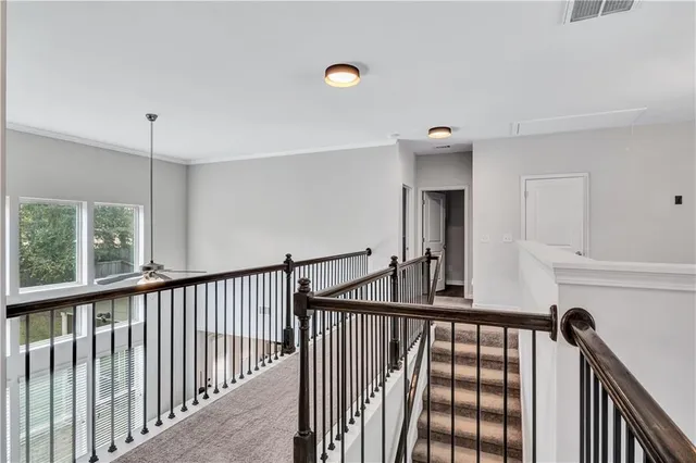 a view of a hallway with entryway and staircase