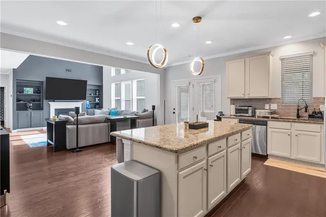 a kitchen with a sink cabinets and wooden floor