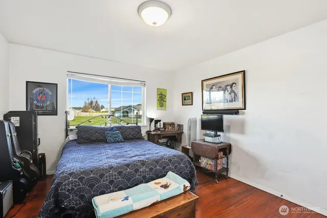 a bathroom with a granite countertop sink toilet a mirror and shower
