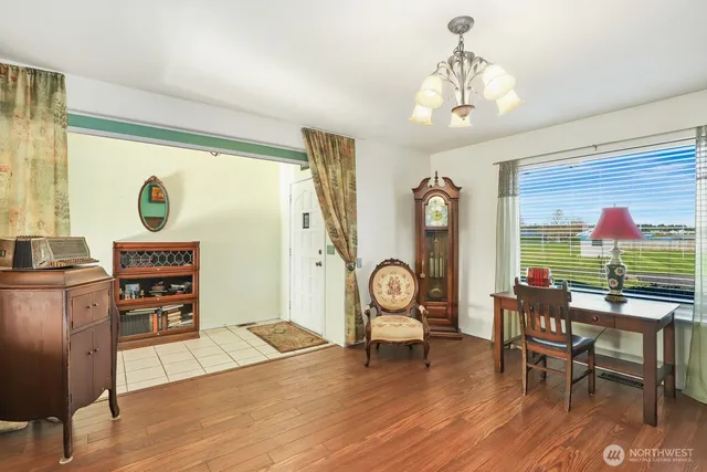 a kitchen with stainless steel appliances granite countertop table chairs sink and cabinets