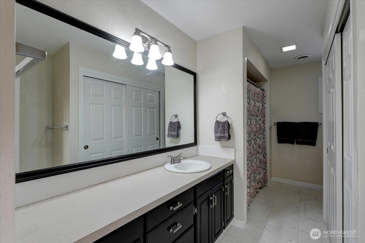 680 Southeast Prospect Street Chehalis, WA 98532 - Photo 21 of 39 a bathroom with a sink a light fixture and a mirror