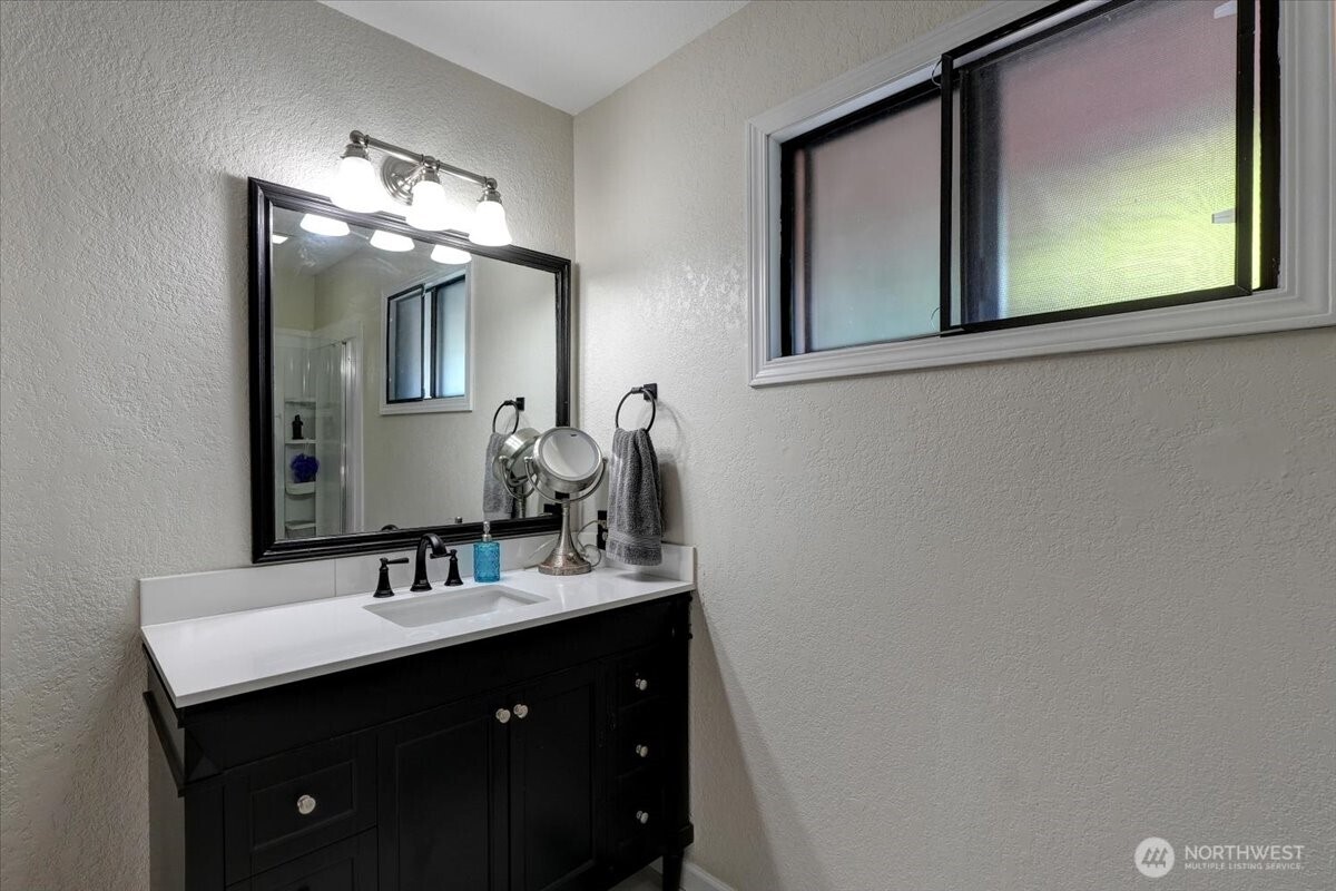 680 Southeast Prospect Street Chehalis, WA 98532 - Photo 25 of 39 a bathroom with a double vanity sink and mirror