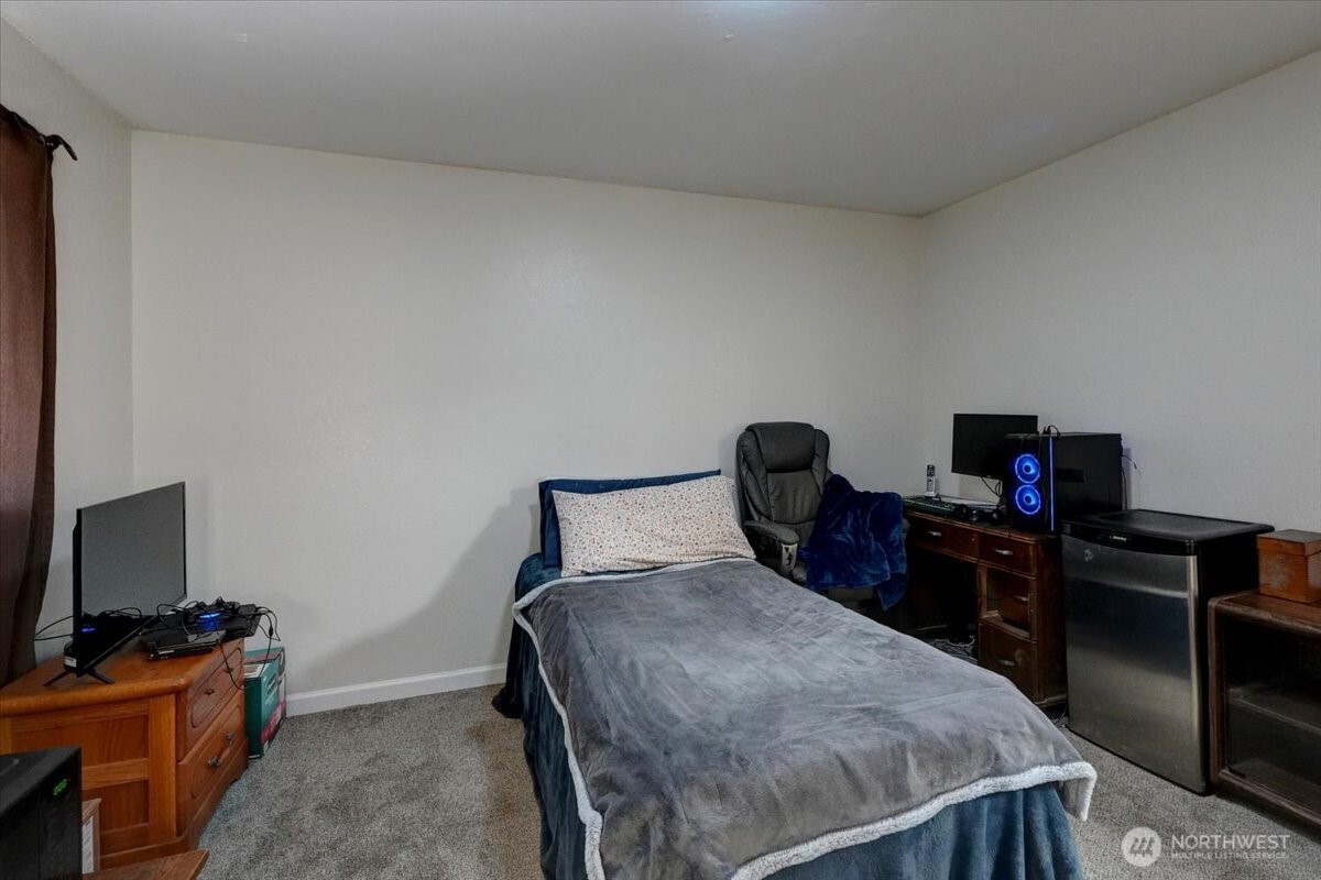 680 Southeast Prospect Street Chehalis, WA 98532 - Photo 28 of 39 a bedroom with a bed and a flat screen tv