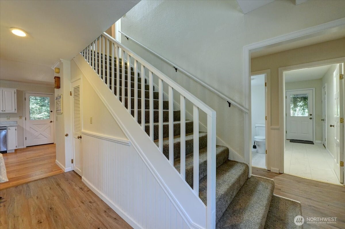 680 Southeast Prospect Street Chehalis, WA 98532 - Photo 4 of 39 a view of a hallway with wooden floor and stairs