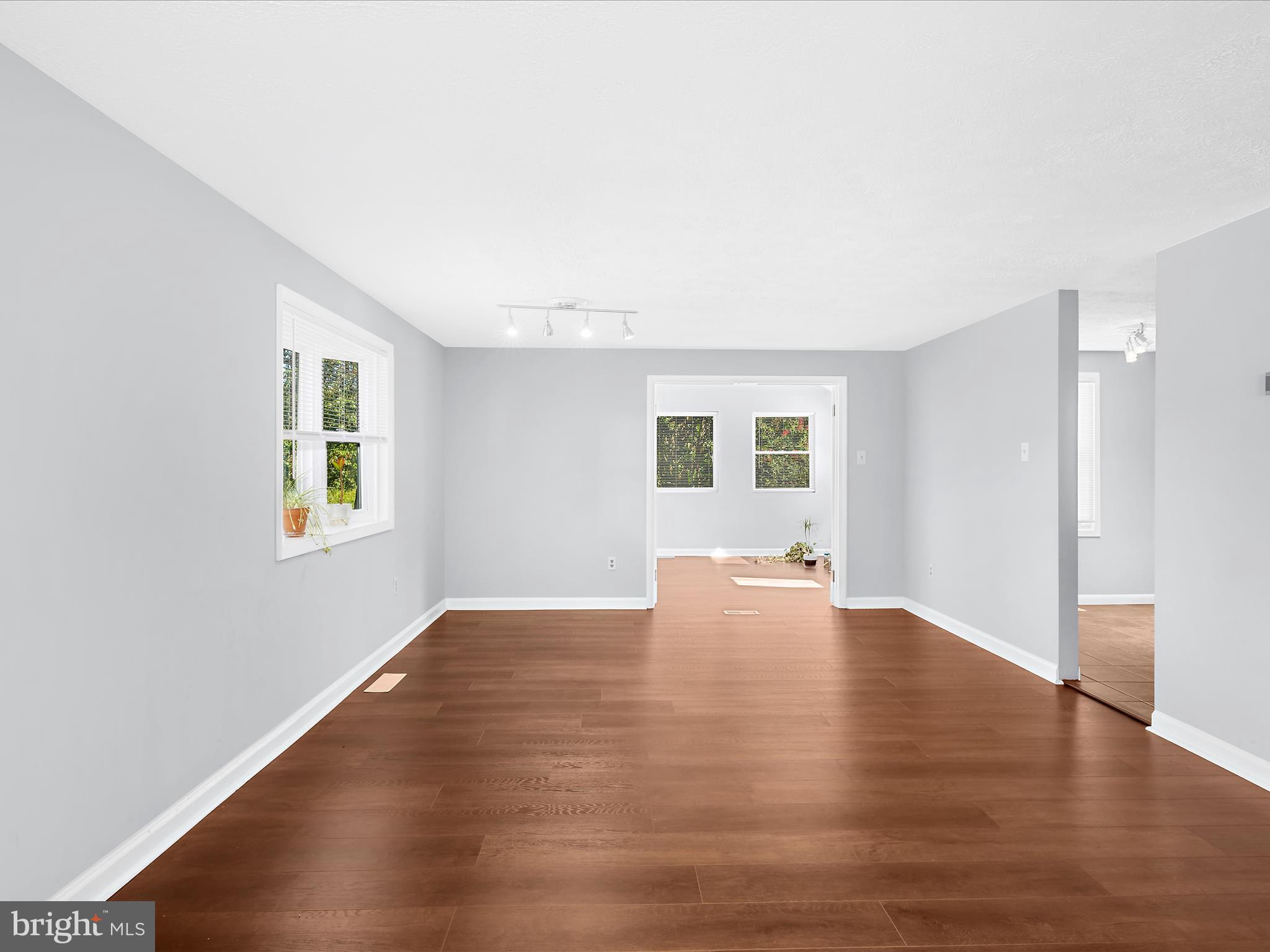 6589 Robin Song Columbia, MD 21045 - Photo 21 of 31 a view of an empty room with window and wooden floor