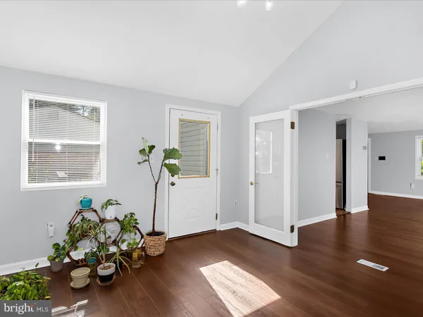 a view of a entryway of wooden floor and a window