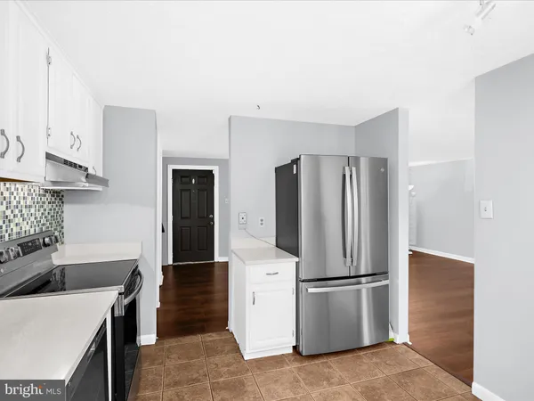 a kitchen with stainless steel appliances a refrigerator sink and stove