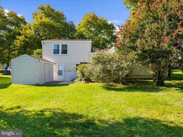 a view of a house with swimming pool and a yard