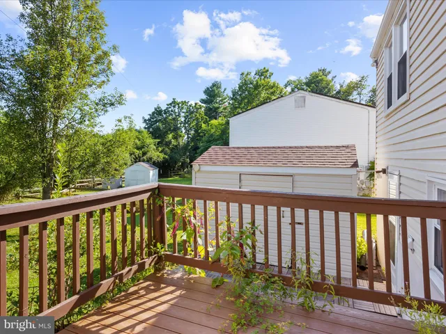 a balcony with wooden floor and outdoor space
