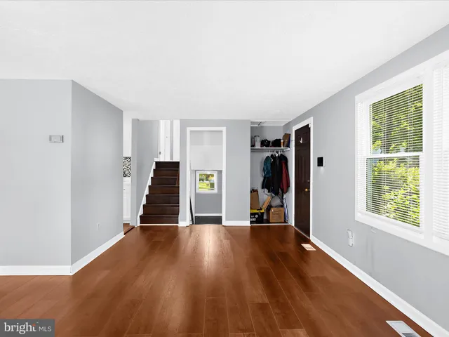 a view of a livingroom with wooden floor and a window