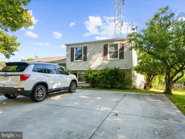 a view of a car parked front of a house