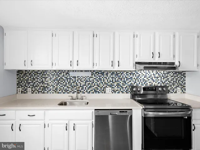 a kitchen with a sink and cabinets
