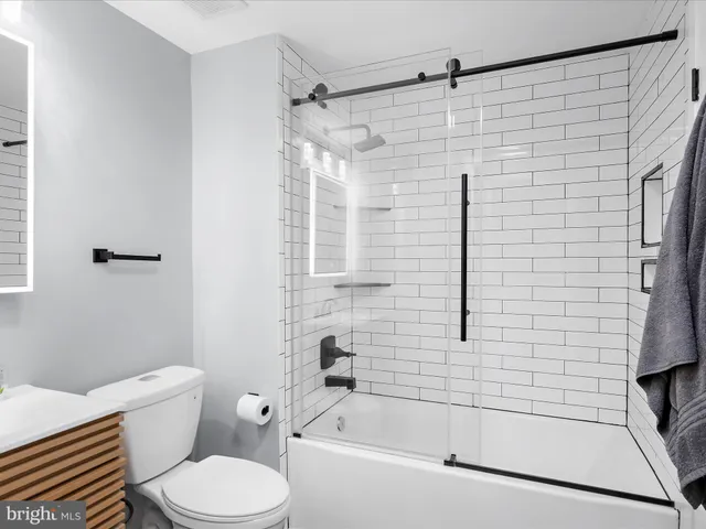 a bathroom with a toilet and a bathtub