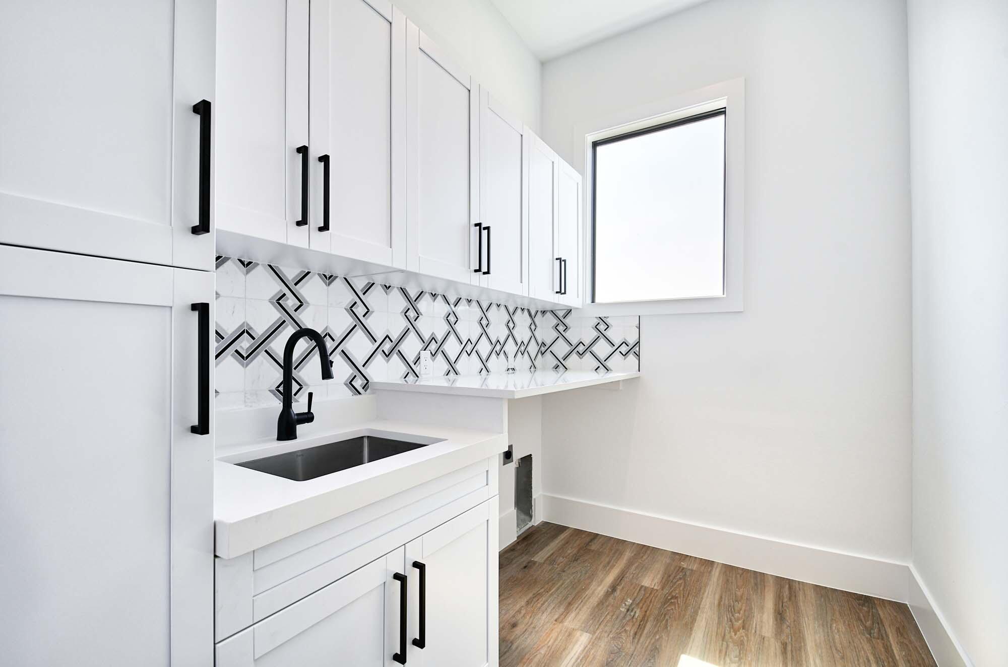 143 Trinidad Street Naples, FL 34113 - Photo 28 of 62 a kitchen with a sink a cabinets and window