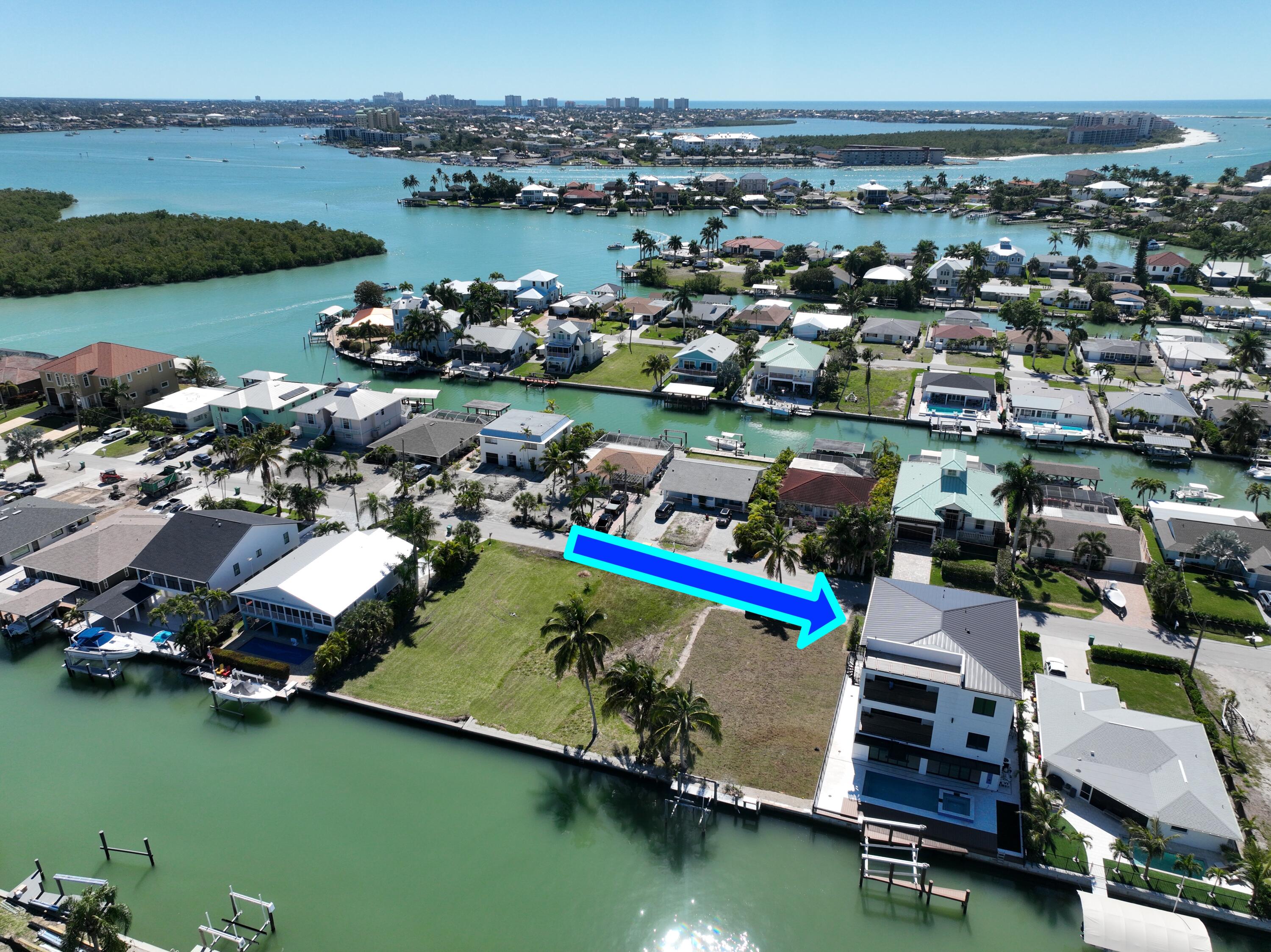 143 Trinidad Street Naples, FL 34113 - Photo 54 of 62 an aerial view of a houses with outdoor space and lake view