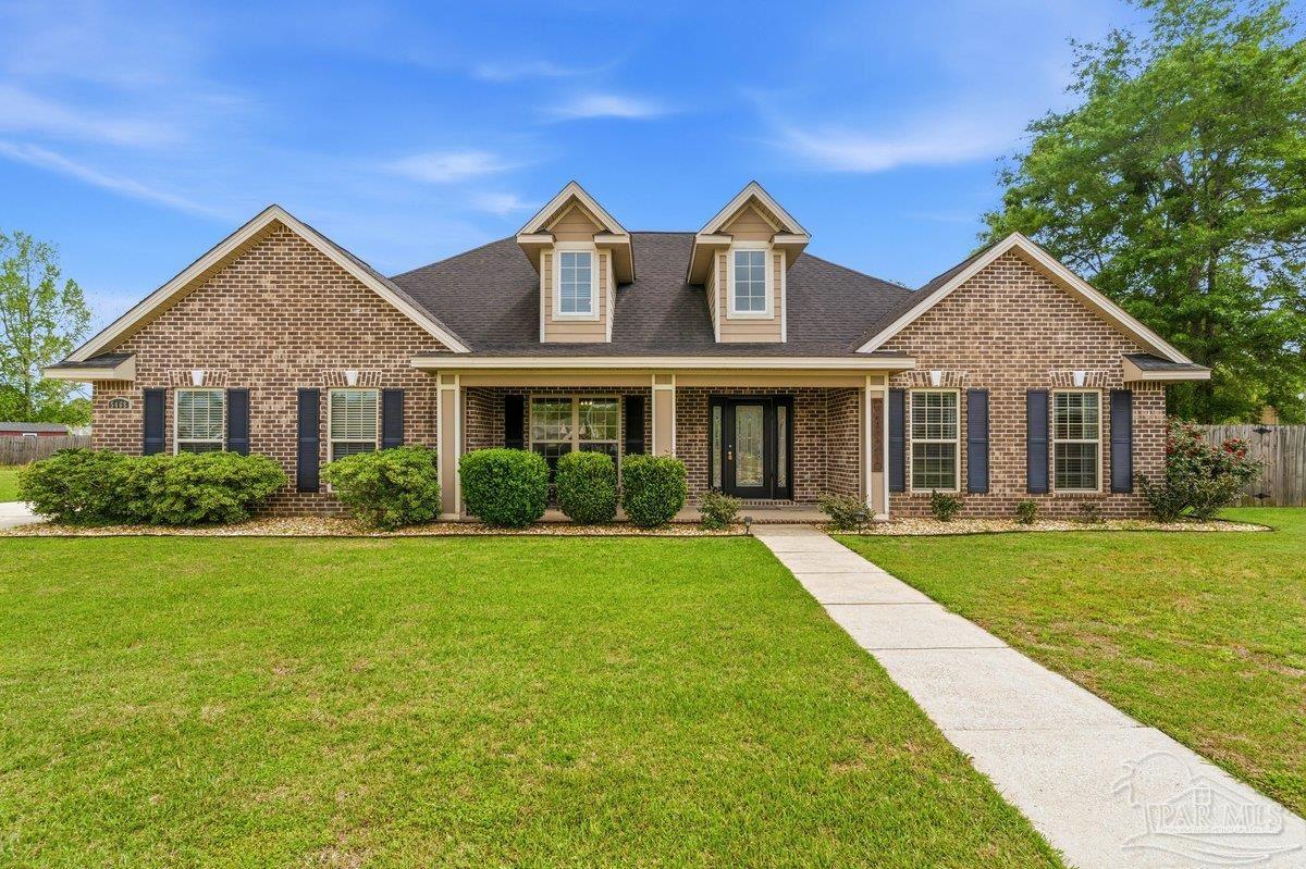 a front view of a house with garden and porch