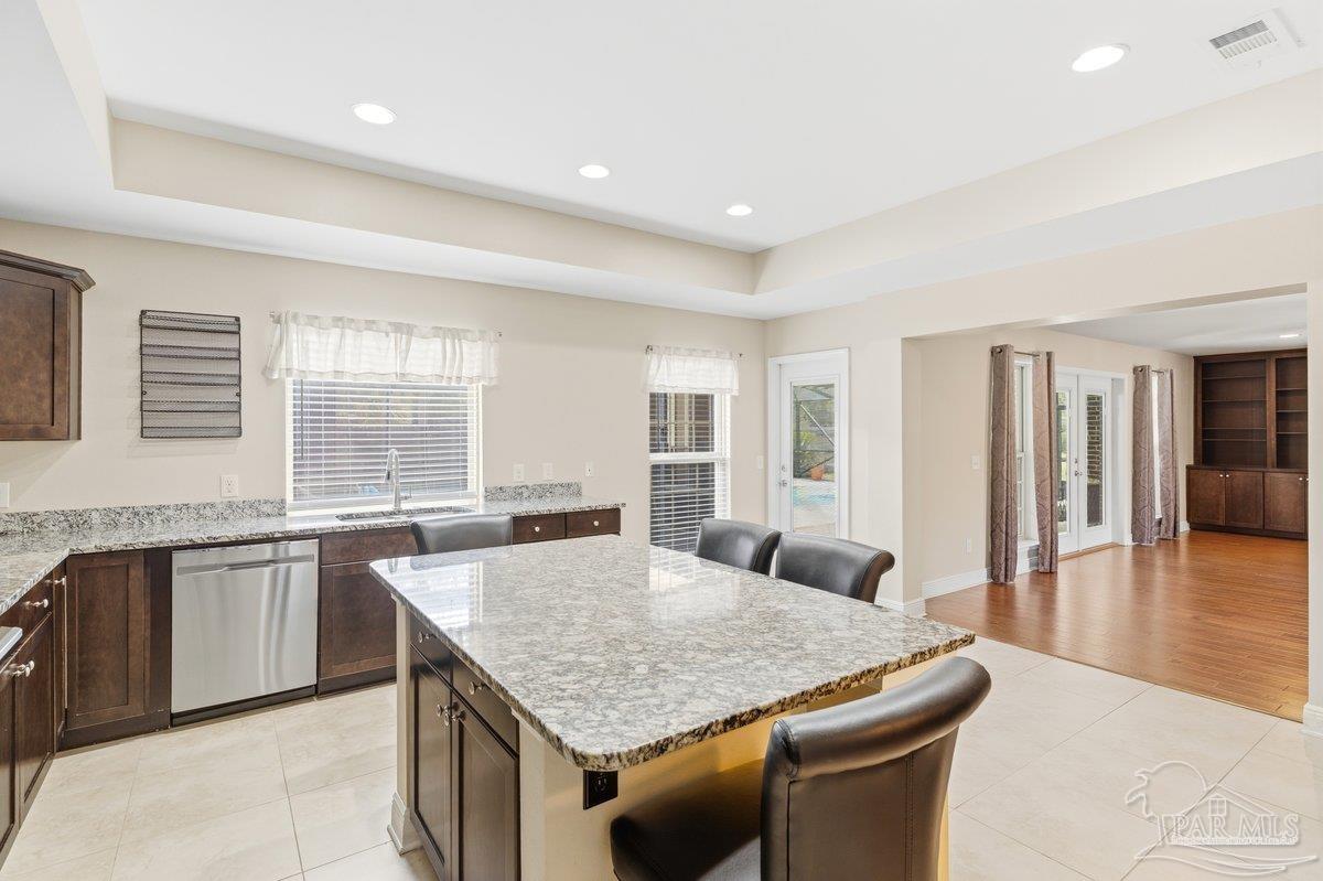 5468 Madelines Way Pace, FL 32571 - Photo 14 of 46 a kitchen with stainless steel appliances granite countertop a kitchen island a stove and a sink