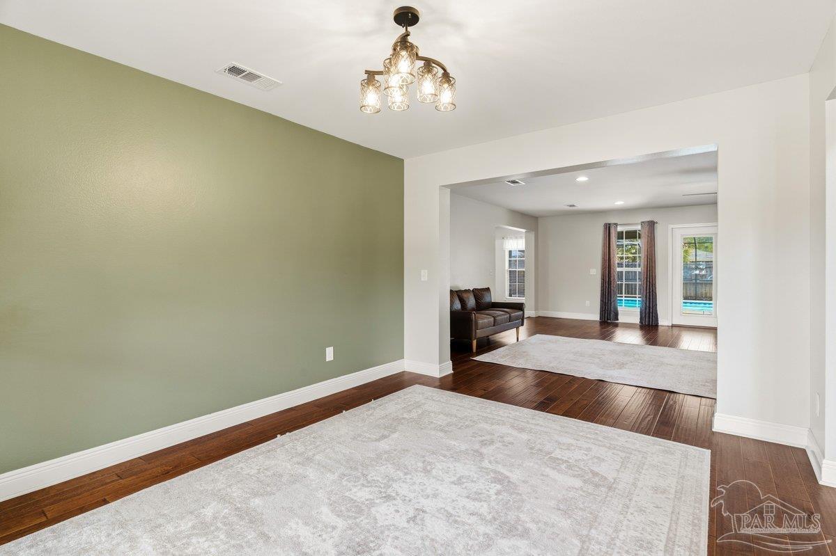 5468 Madelines Way Pace, FL 32571 - Photo 19 of 46 a view of a livingroom with a chandelier