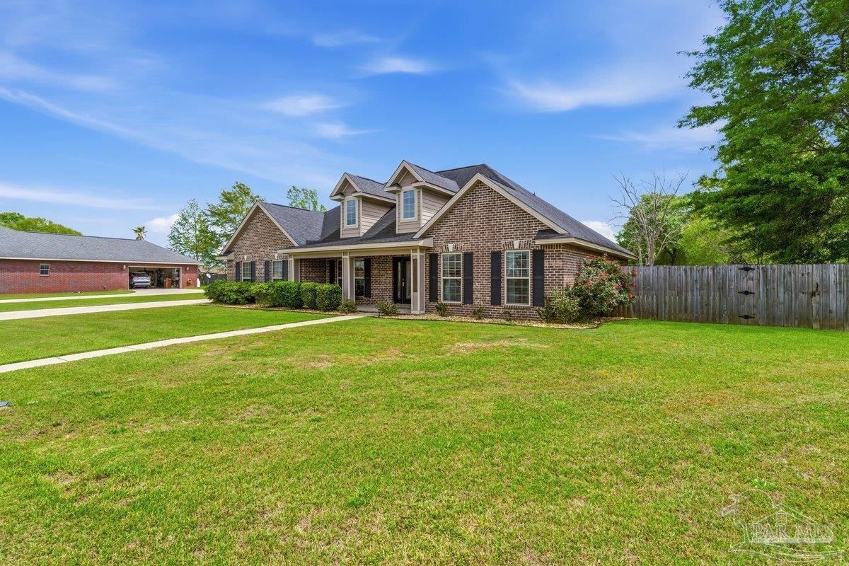 5468 Madelines Way Pace, FL 32571 - Photo 2 of 46 a front view of a house with garden