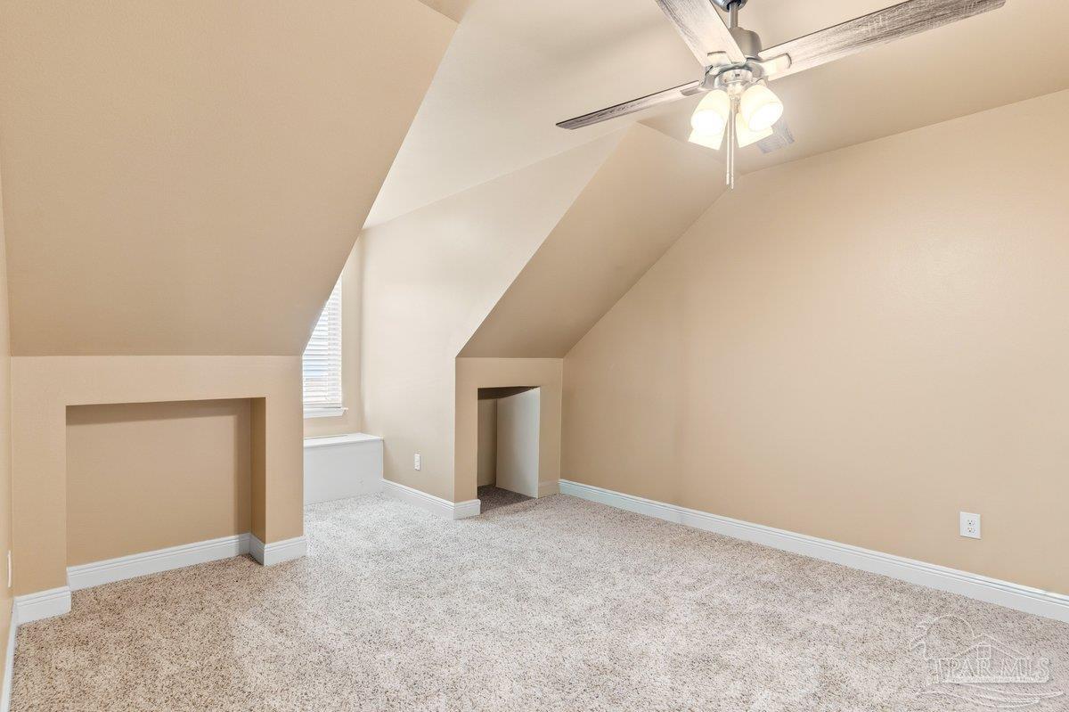 5468 Madelines Way Pace, FL 32571 - Photo 22 of 46 an empty room with a ceiling fan and carpet
