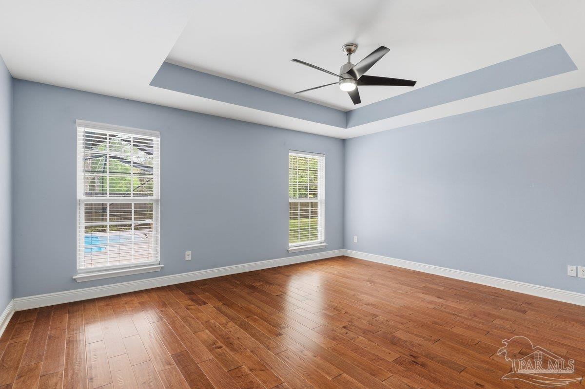 5468 Madelines Way Pace, FL 32571 - Photo 30 of 46 wooden floor in an empty room with a window