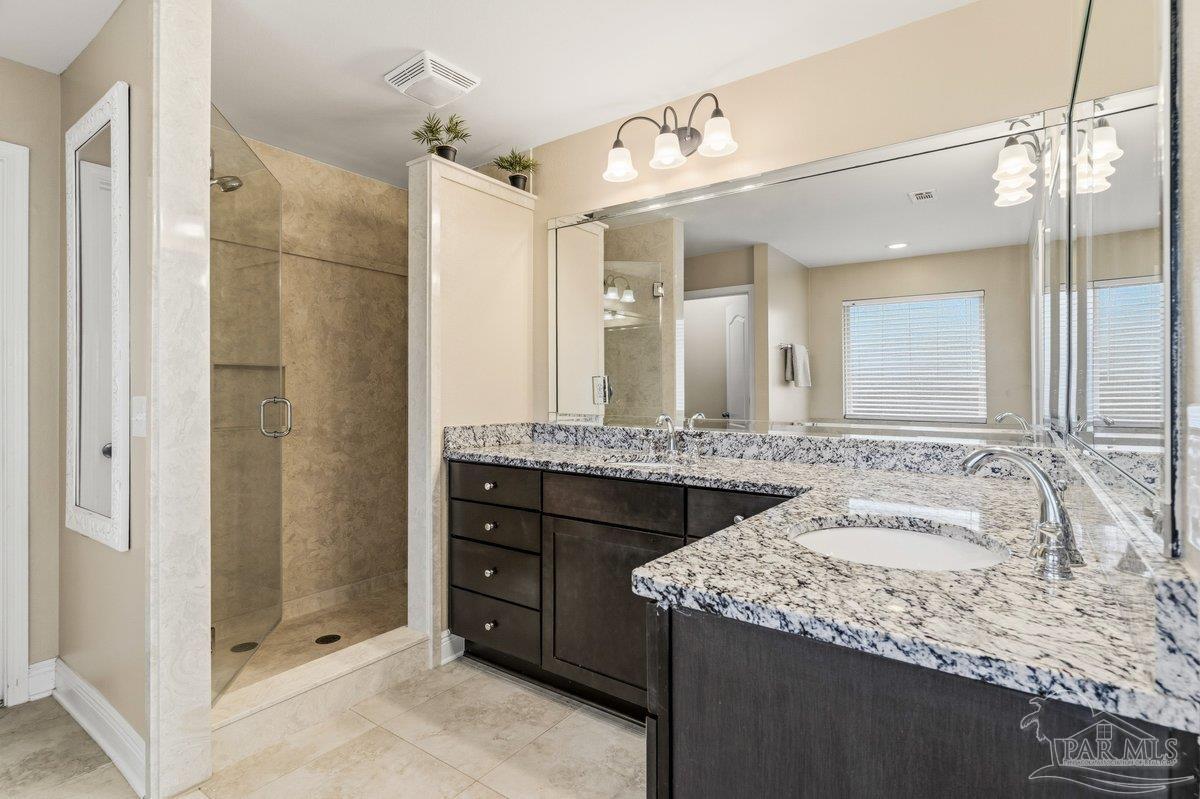5468 Madelines Way Pace, FL 32571 - Photo 32 of 46 a bathroom with a granite countertop sink and a mirror