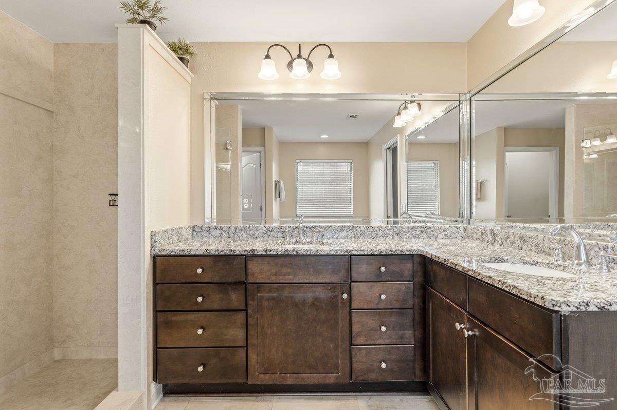 5468 Madelines Way Pace, FL 32571 - Photo 33 of 46 a bathroom with a granite countertop sink vanity and a mirror
