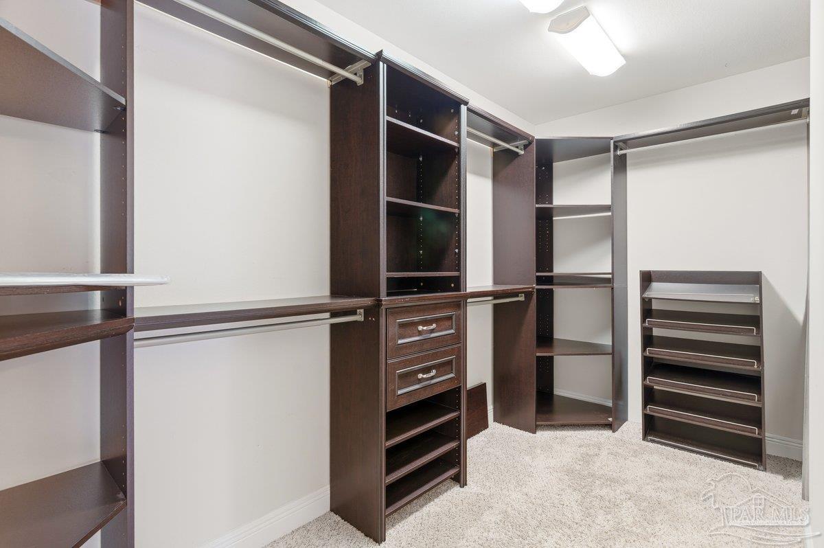 5468 Madelines Way Pace, FL 32571 - Photo 35 of 46 a view of walk in closet with empty racks
