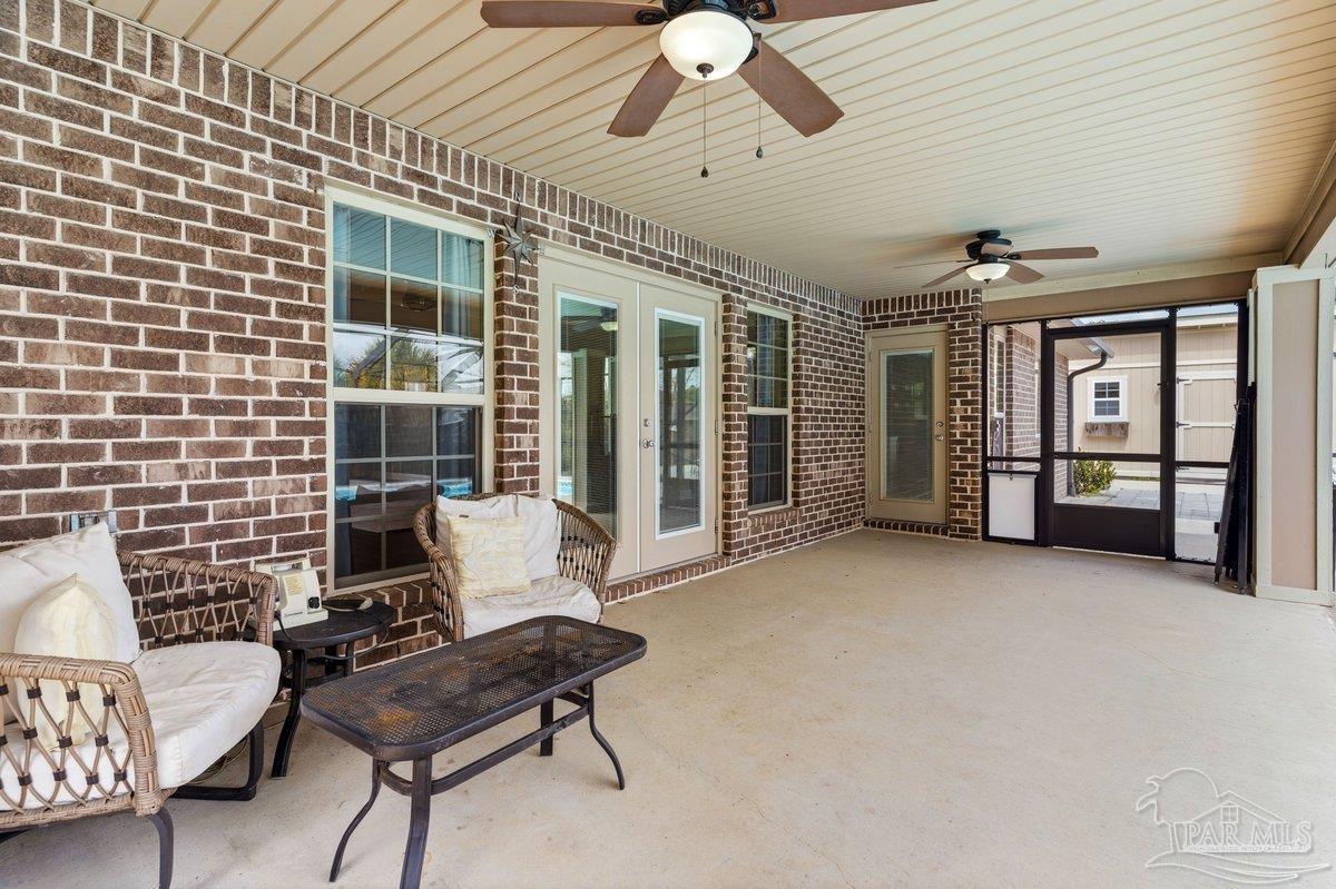 5468 Madelines Way Pace, FL 32571 - Photo 37 of 46 a building outdoor space with patio furniture and potted plants