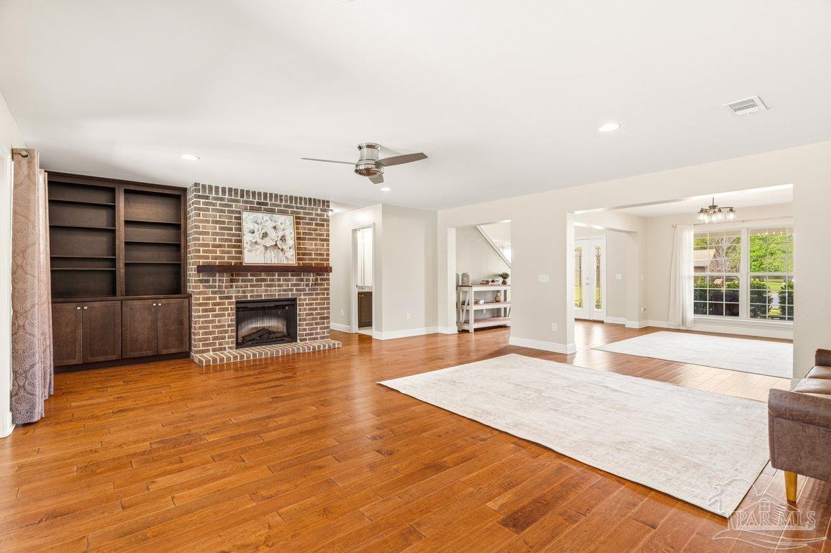 5468 Madelines Way Pace, FL 32571 - Photo 4 of 46 a view of an empty room with a fireplace and a window