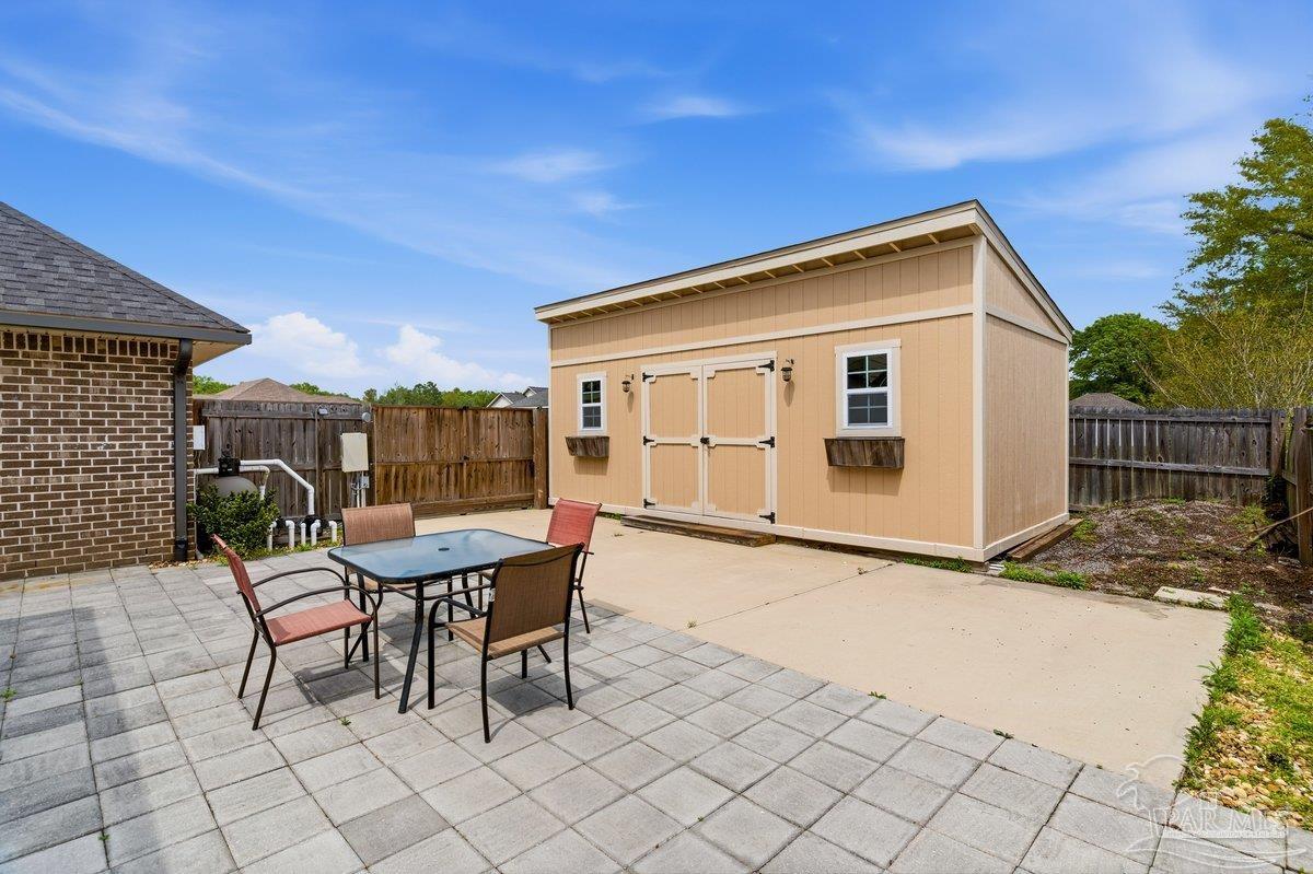 5468 Madelines Way Pace, FL 32571 - Photo 43 of 46 a backyard of a house with table and chairs