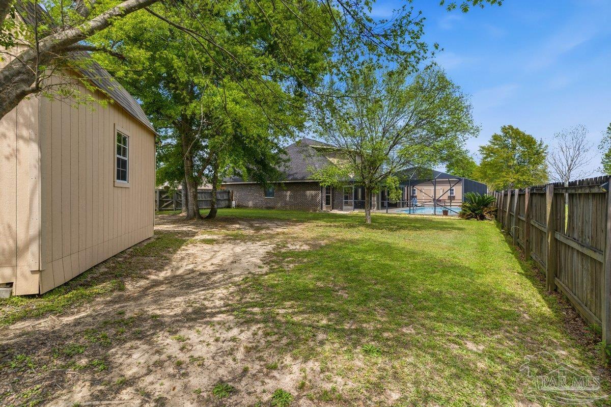 5468 Madelines Way Pace, FL 32571 - Photo 44 of 46 a view of a house with backyard and tree
