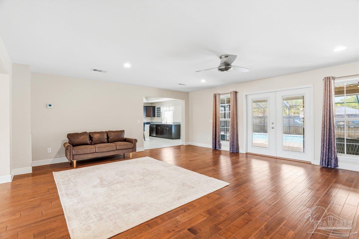 5468 Madelines Way Pace, FL 32571 - Photo 6 of 46 a living room with furniture and wooden floor