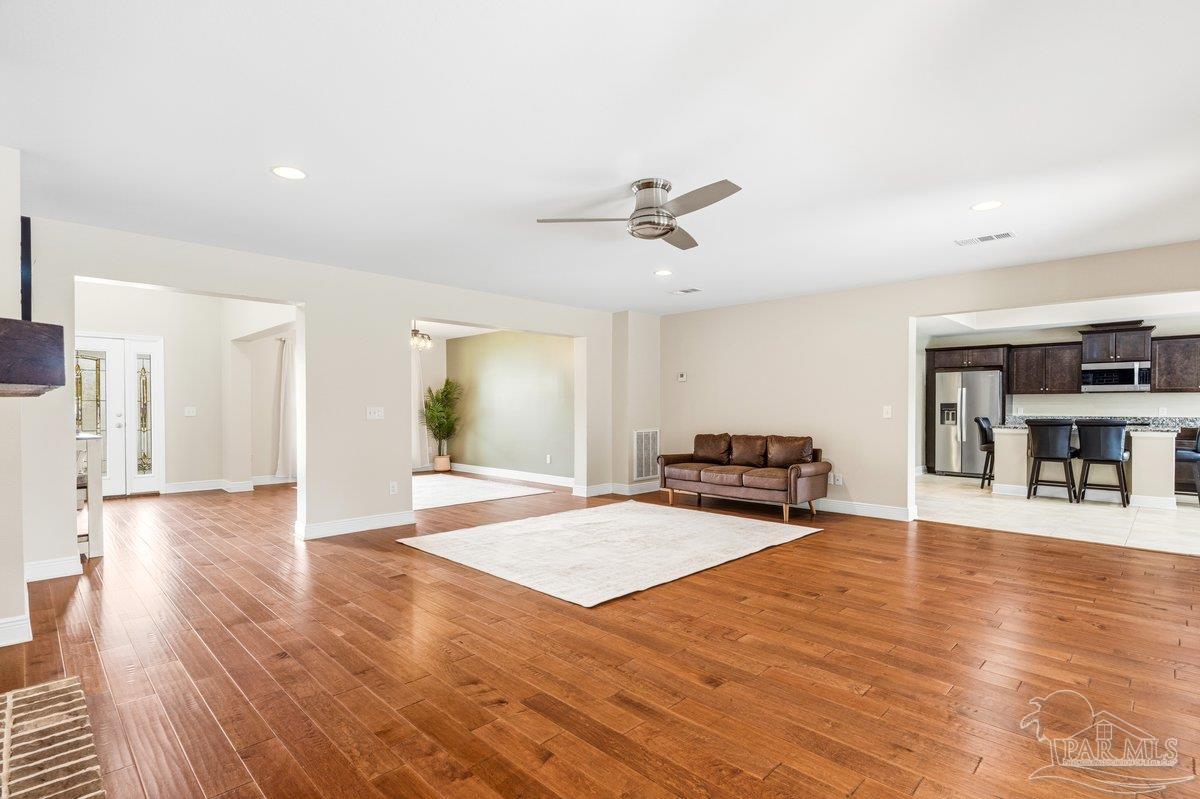 5468 Madelines Way Pace, FL 32571 - Photo 7 of 46 a living room with furniture and wooden floor