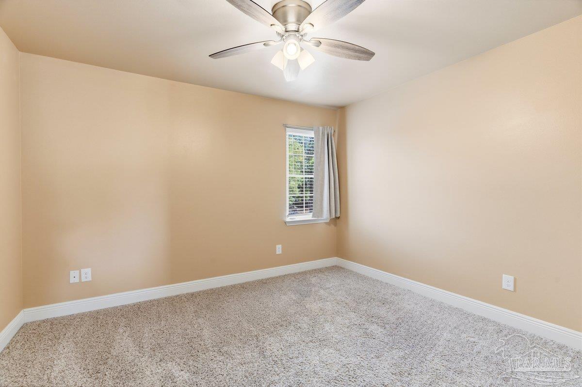 5468 Madelines Way Pace, FL 32571 - Photo 10 of 46 a view of an empty room with a window