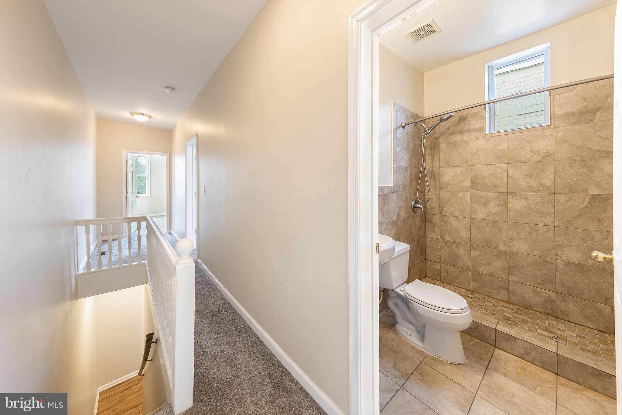 1388 Northeast E Street Northeast Washington, DC 20002 - Photo 17 of 28 a bathroom with a granite countertop bathtub shower sink and toilet