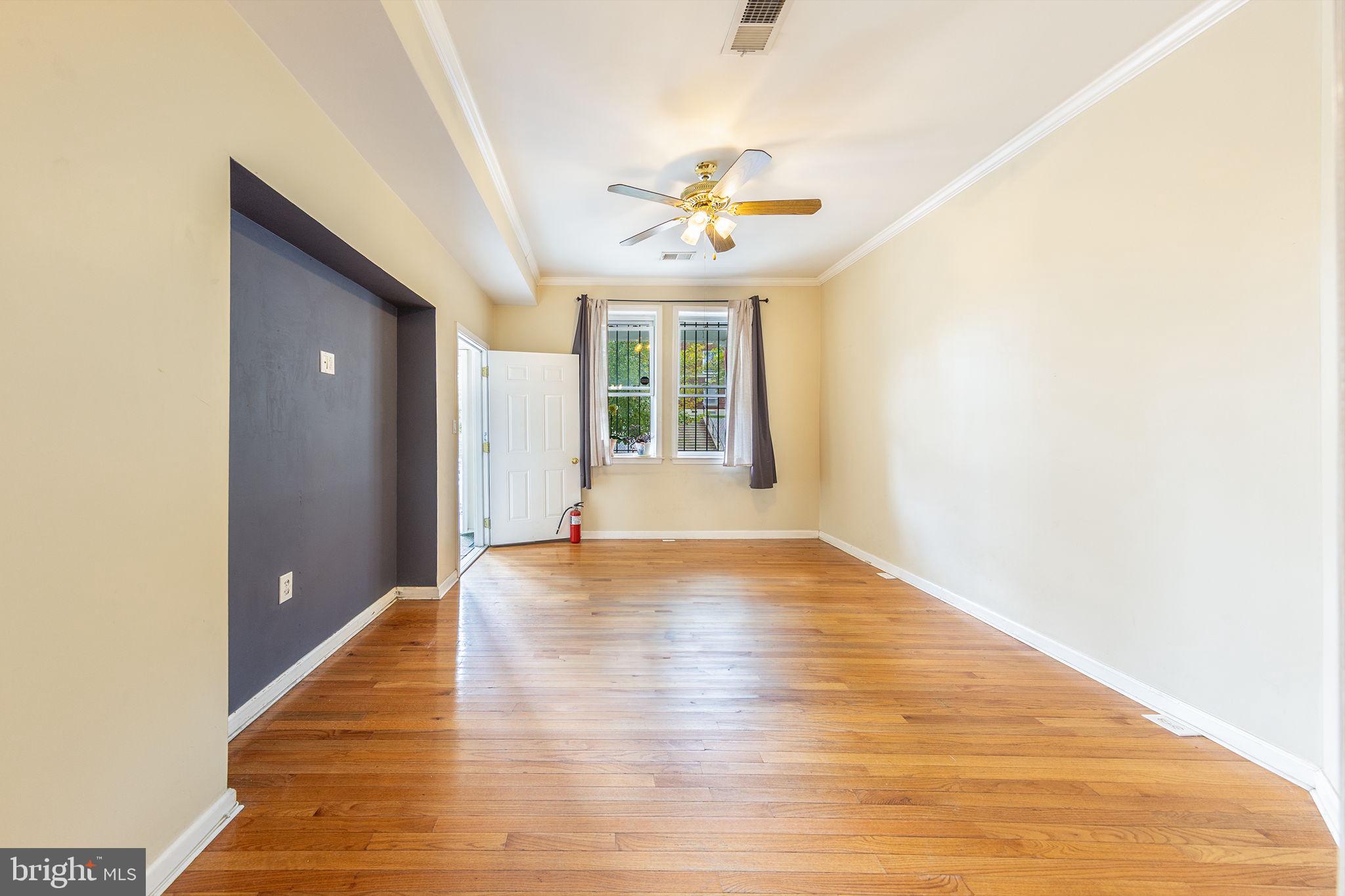 1388 Northeast E Street Northeast Washington, DC 20002 - Photo 22 of 28 a view of an empty room with wooden floor and a window