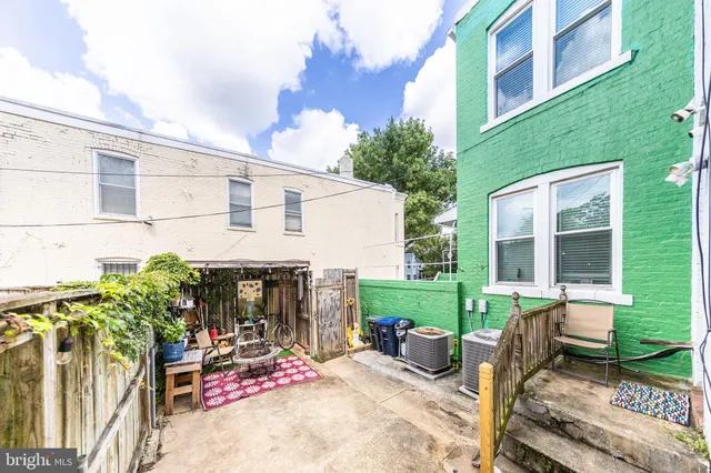 a balcony with furniture and a potted plant