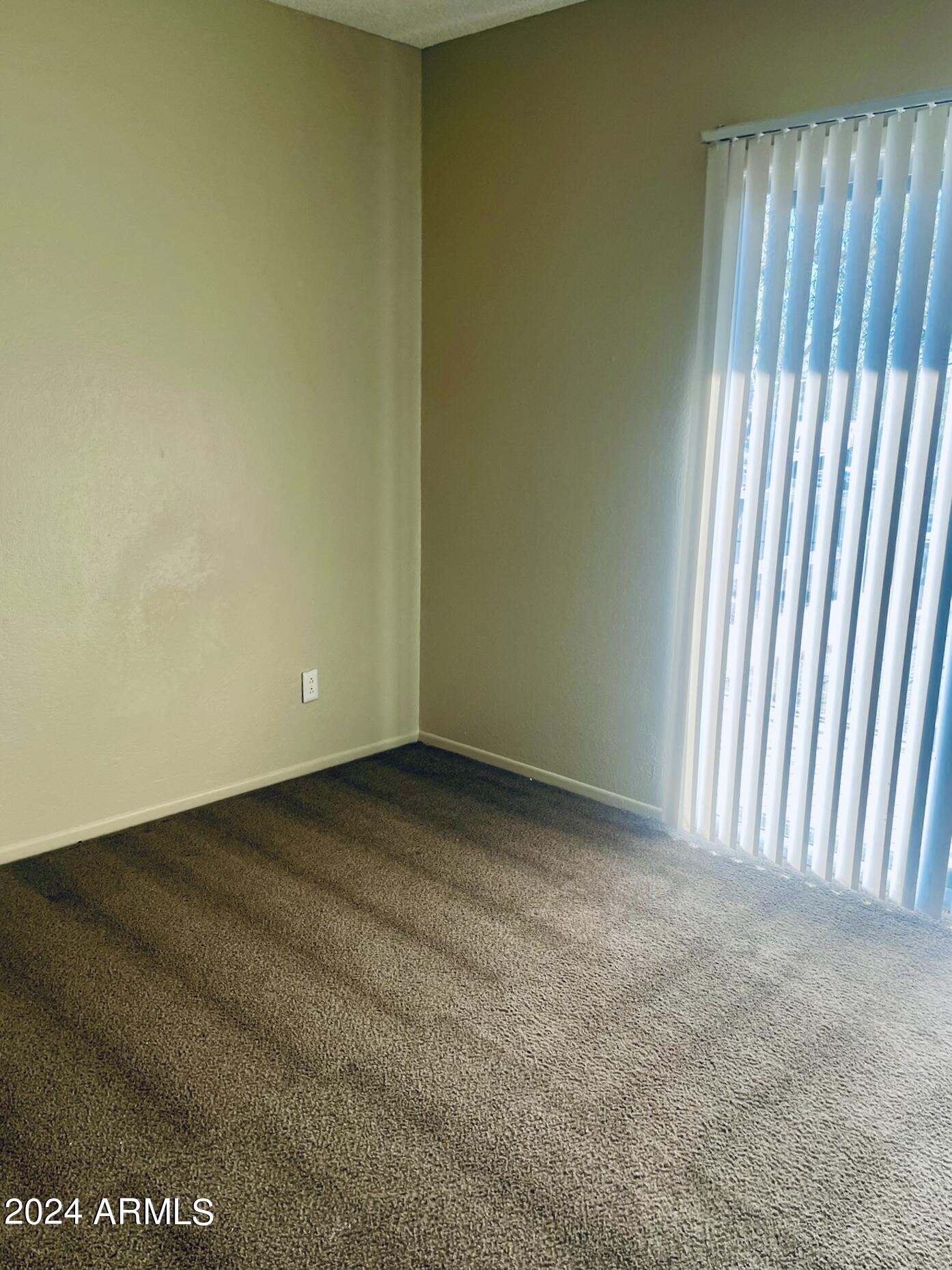 2846 East Kathleen Road, Unit 103 Phoenix, AZ 85032 - Photo 11 of 17 a view of an empty room with a window