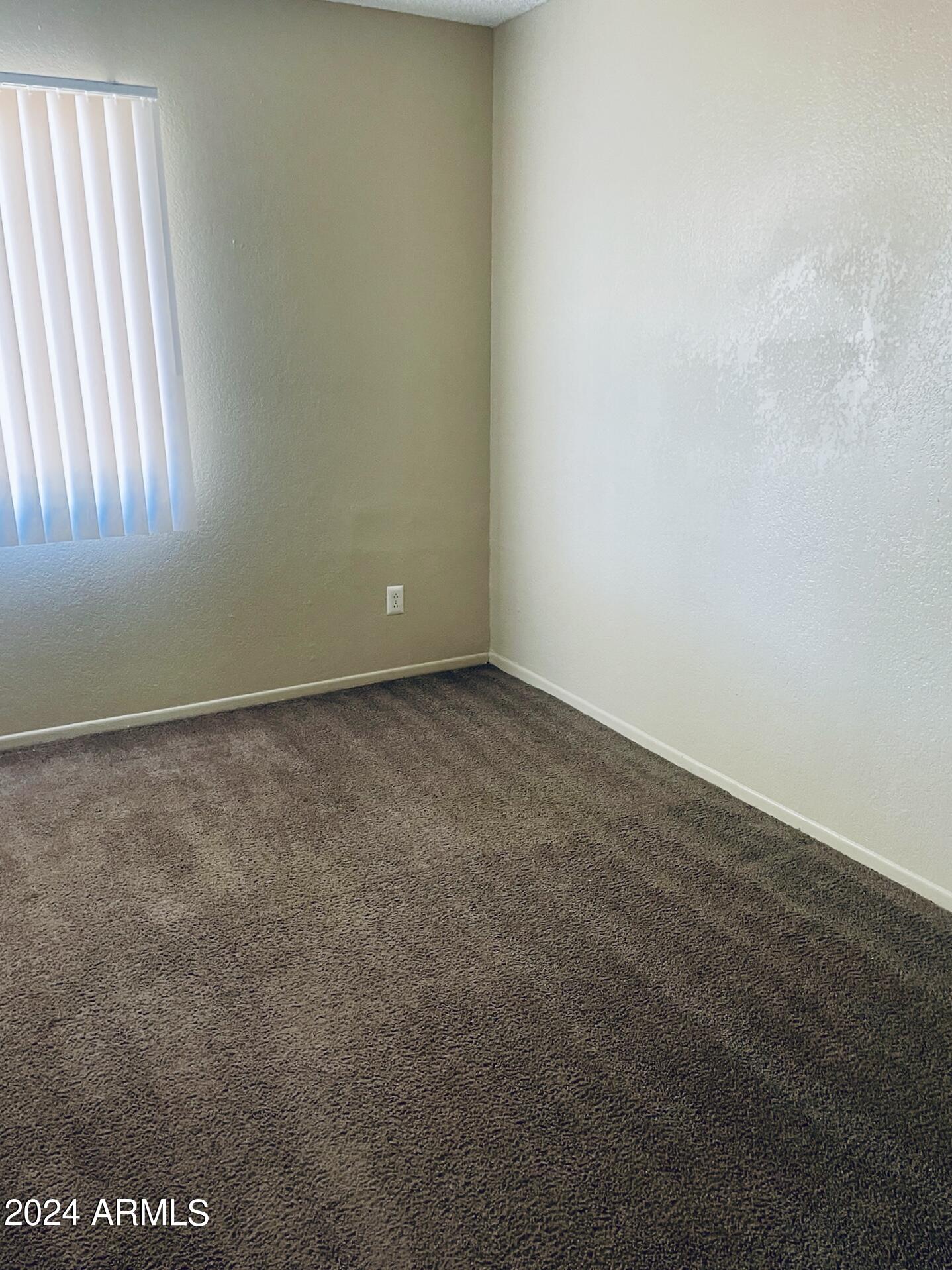 2846 East Kathleen Road, Unit 103 Phoenix, AZ 85032 - Photo 13 of 17 an empty room with a window