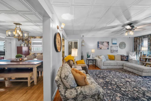 a living room with furniture and a chandelier