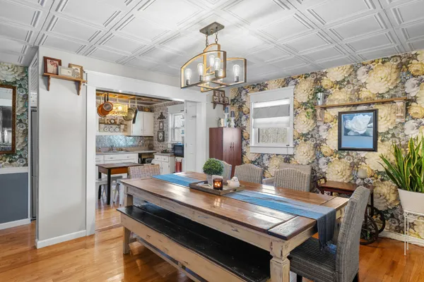 a view of a dining room with furniture wooden floor and chandelier