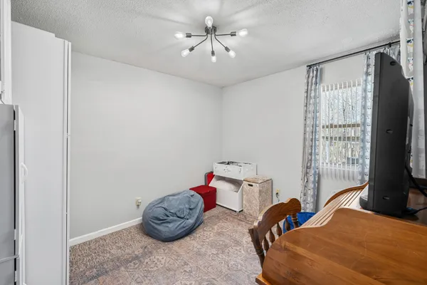a bedroom with bed and a window