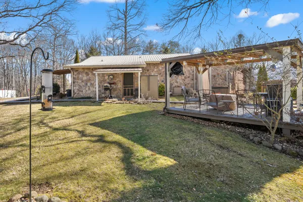 a view of a house with backyard and sitting area