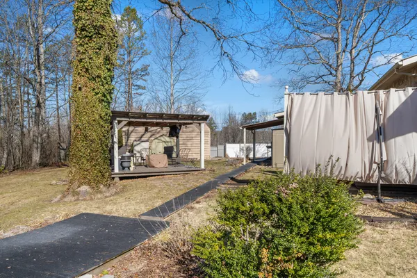 a view of a house with a yard and tree s