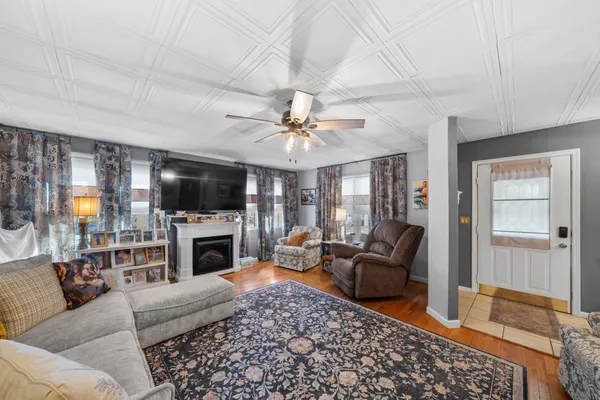 a living room with furniture a flat screen tv and a fireplace