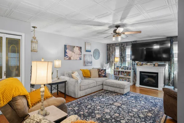 a living room with furniture a flat screen tv and a fireplace