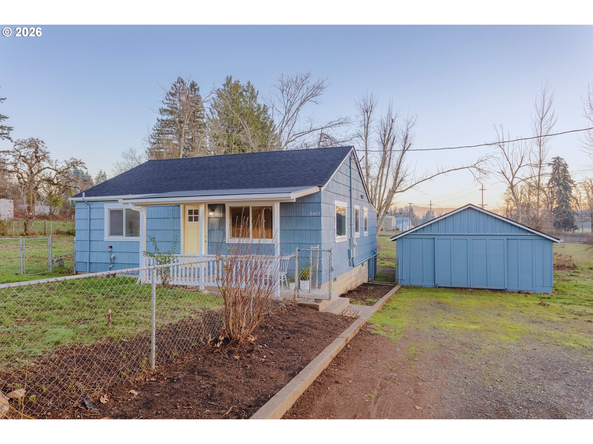 a view of a house with yard and a tree