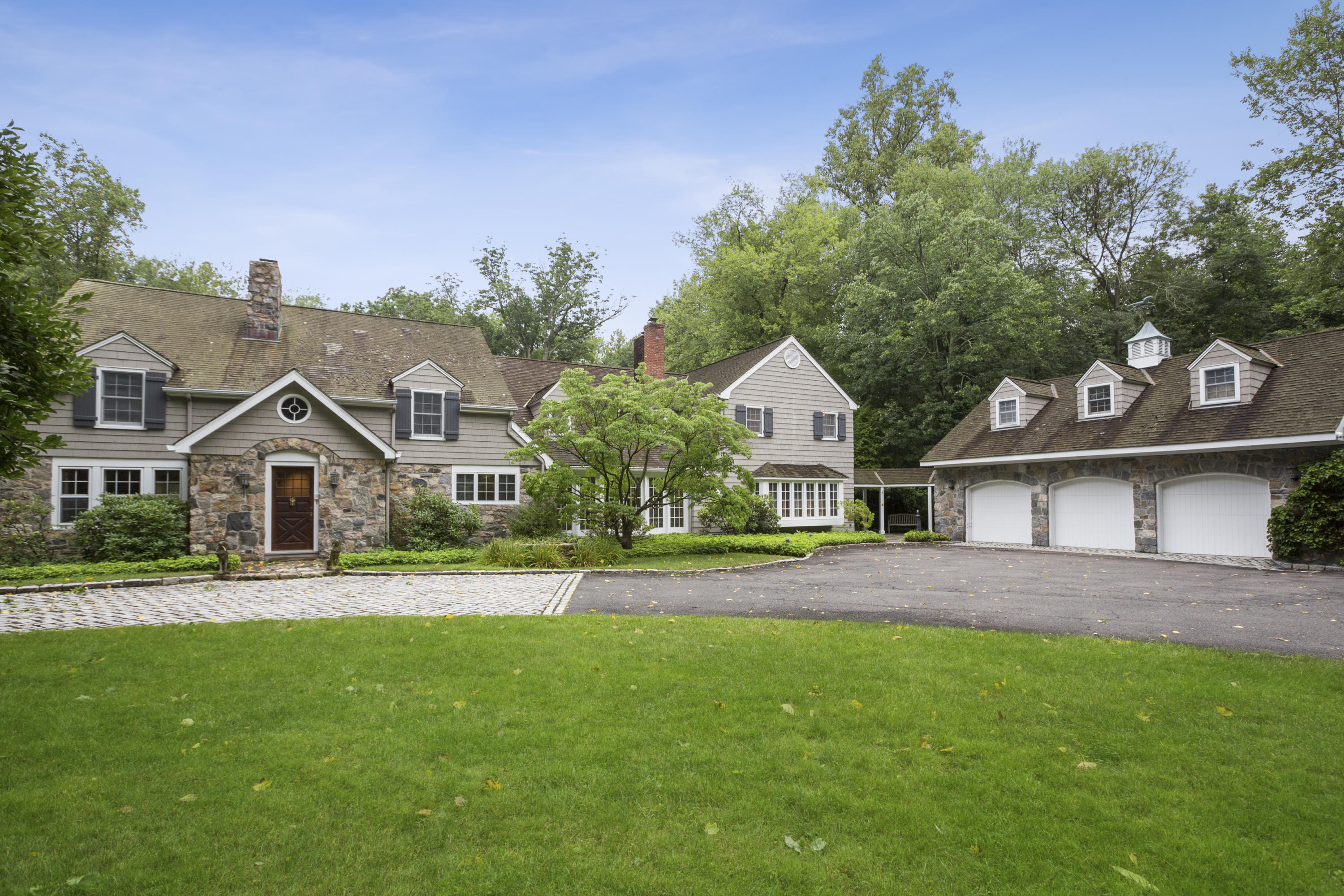 283 Hollow Tree Ridge Road Darien, CT 06820 - Photo 1 of 49 a front view of a house with a yard